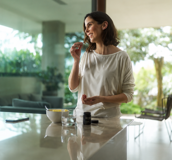 Woman taking almä Daily Gut Health at home
